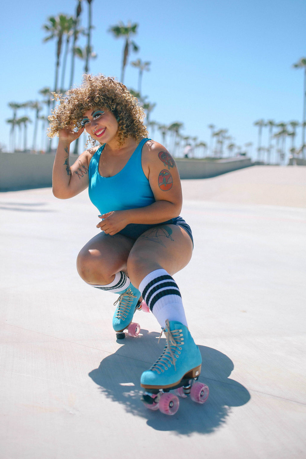 Close outdoor view of True Blue Moxi Lolly Malibu Barbie skates with pink outdoor wheels